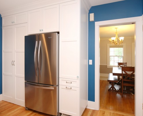 Doors to the left of the refrigerator are the hidden entrance into the basement.